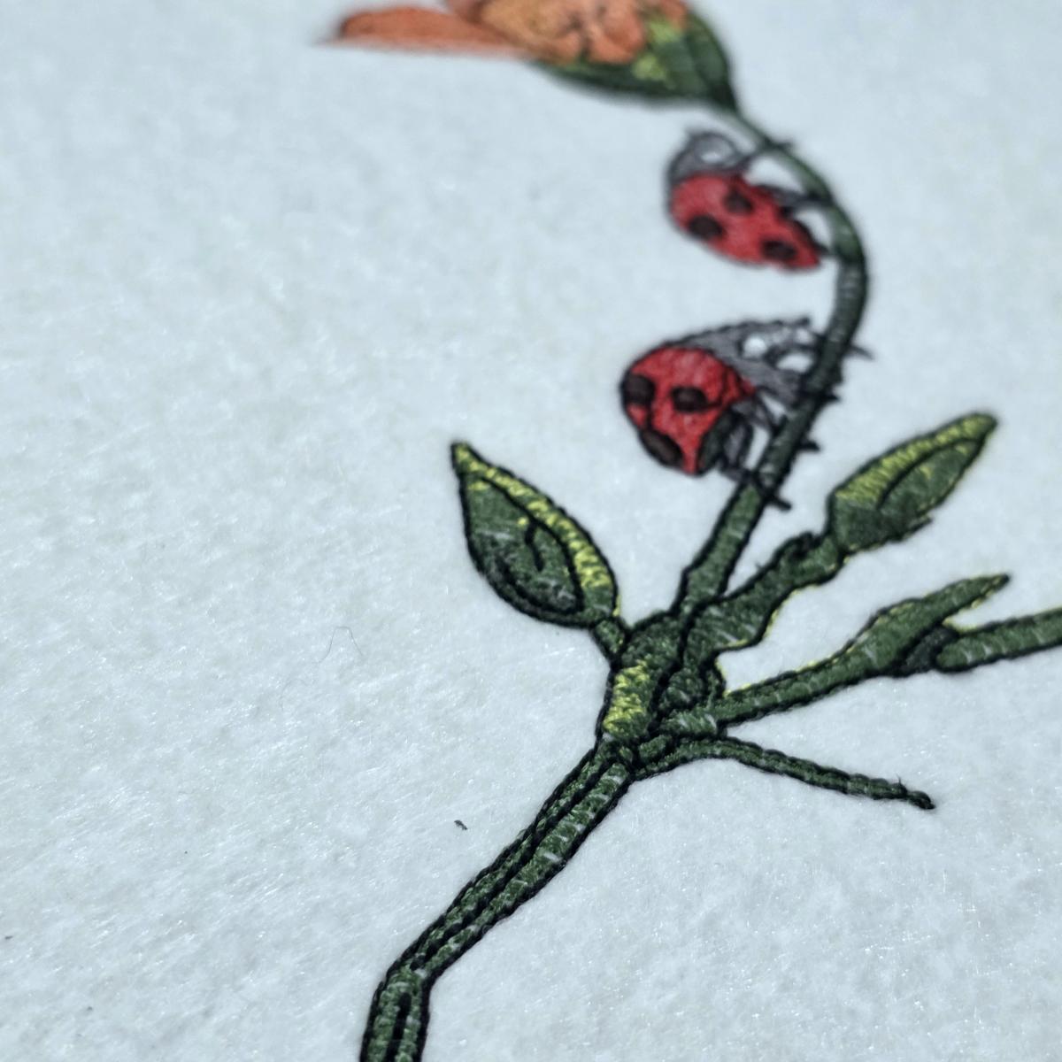 ladybug-on-flower-stem-embroidery-design