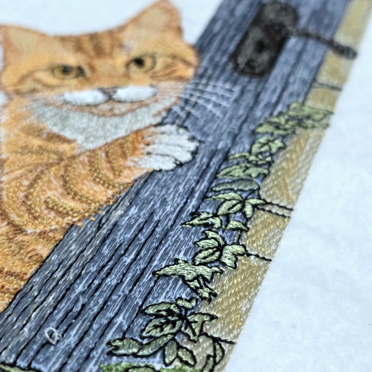 playful-ginger-peeking-cat-embroidery-design