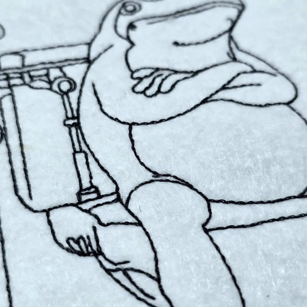 grumpy-frog-on-toilet-line-art-embroidery-design
