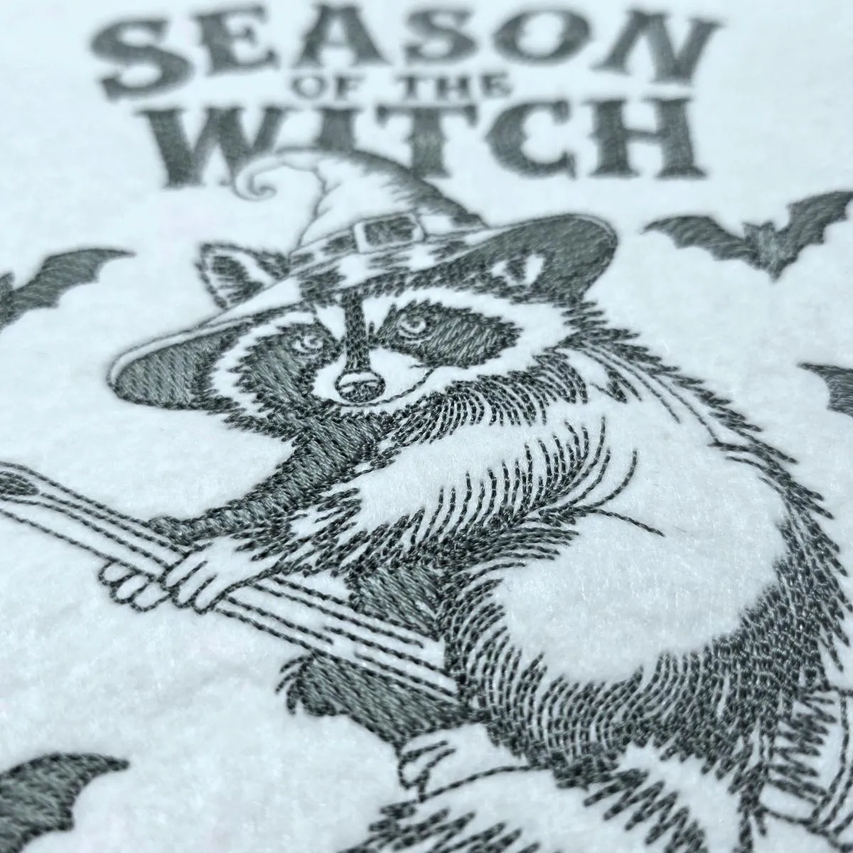 spooky-raccoon-on-a-broom-embroidery-design